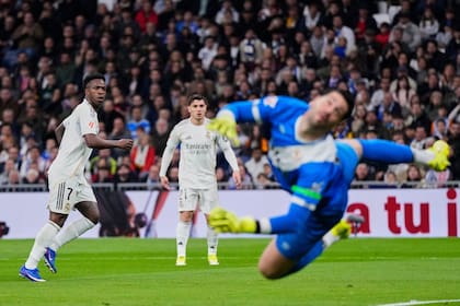 Vinicius Junior observa cómo la estira del argentino Augusto Batalla no alcanzará: el brasileño anotó el primer gol de Real Madrid ante Rayo Vallecano