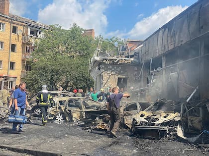 In this photo provided by the Ukrainian Emergency Service, rescuers work on a scene of building damaged by shelling, in Vinnytsia, Ukraine, Thursday, July 14, 2022. (Ukrainian Emergency Service via AP)