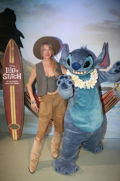 Virginia Da Cunha posó con Stitch para los flashes. A la cantante no le hizo mella el frío y se destacó por su look canchero de corset y chaleco a tono, una bermuda y botas de caña alta gamuzadas. Completó el outfit con un sombrero