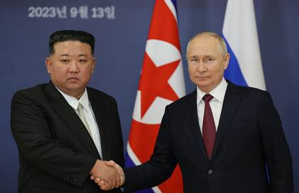 This pool image distributed by Sputnik agency shows Russian President Vladimir Putin (R) and North Korea's leader Kim Jong Un (L) shaking hands during their meeting at the Vostochny Cosmodrome in Amur region on September 13, 2023, ahead of planned talks that could lead to a weapons deal with Russian President. (Photo by Vladimir SMIRNOV / POOL / AFP)