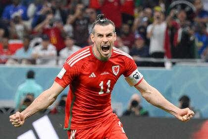 Wales' forward #11 Gareth Bale celebrates scoring his team's first goal during the Qatar 2022 World Cup Group B football match between USA and Wales at the Ahmad Bin Ali Stadium in Al-Rayyan, west of Doha on November 21, 2022. (Photo by NICOLAS TUCAT / AFP)