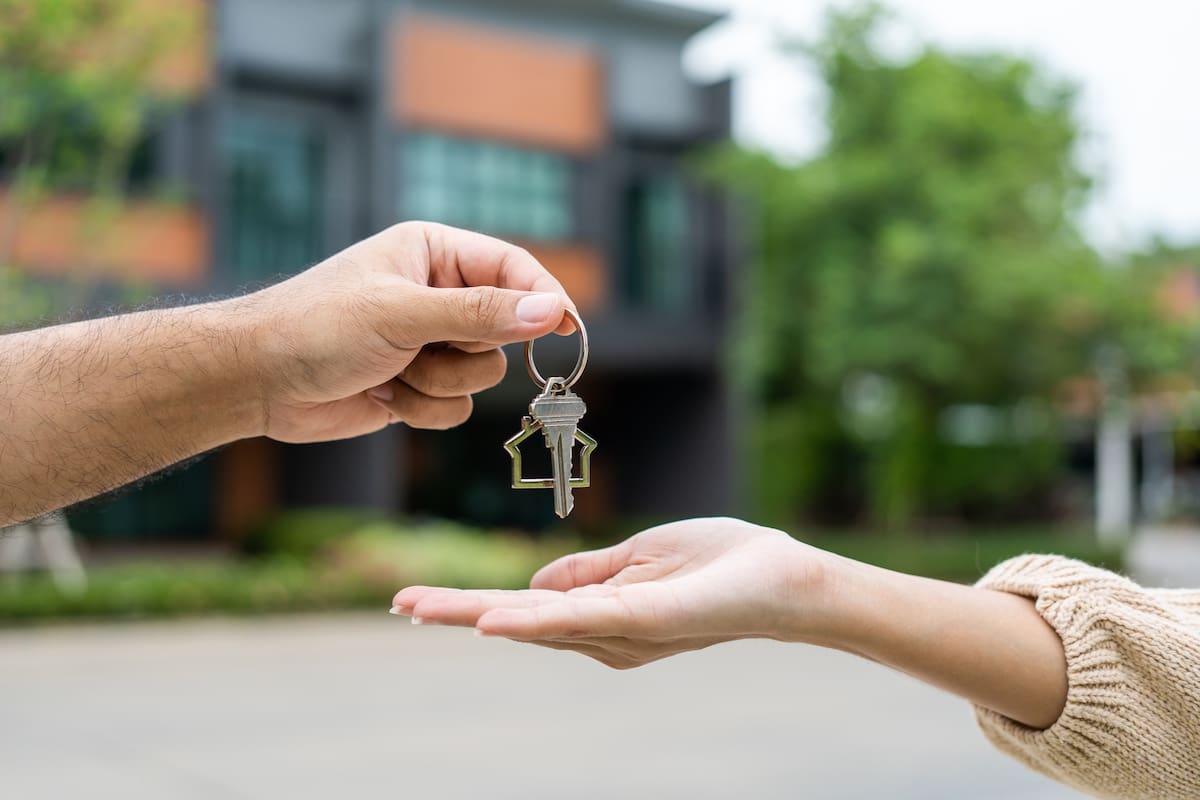 Home 9 woman buying or rent new home she holding key ELBKU54JBZF6BL6GIEYXLF3ZQI