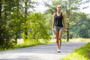 Young woman walks outdoor as workout