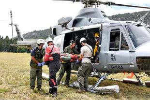 Una de las víctimas es descendida desde el helicóptero en el que se la rescató