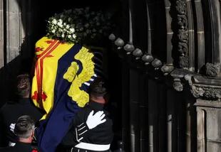 Los portadores de féretros llevan el féretro de la difunta reina Isabel II de Gran Bretaña, cubierto con el estandarte real de Escocia, a la catedral de San Giles en Edimburgo, el 12 de septiembre de 2022.