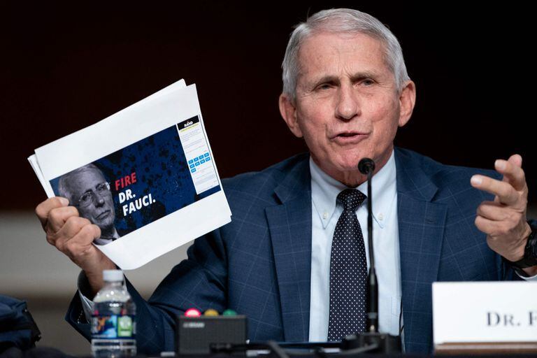 Dr. Anthony Fauci, White House Chief Medical Advisor and Director of the NIAID, shows a screen grab of a campaign website while answering questions from Senator Rand Paul (R-Ky.) during a Senate Health, Education, Labor, and Pensions Committee hearing to examine the federal response to Covid-19 and new emerging variants on January 11, 2022 at Capitol Hill in Washington, DC. (Photo by Greg Nash / POOL / AFP)