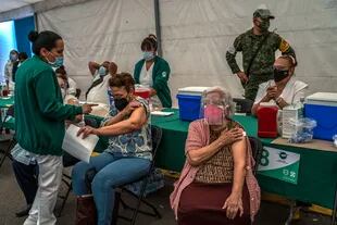 Las personas celebran después de recibir su segunda dosis de la vacuna AstraZeneca contra el Covid-19 en la Ciudad de México, el 14 de abril de 2021