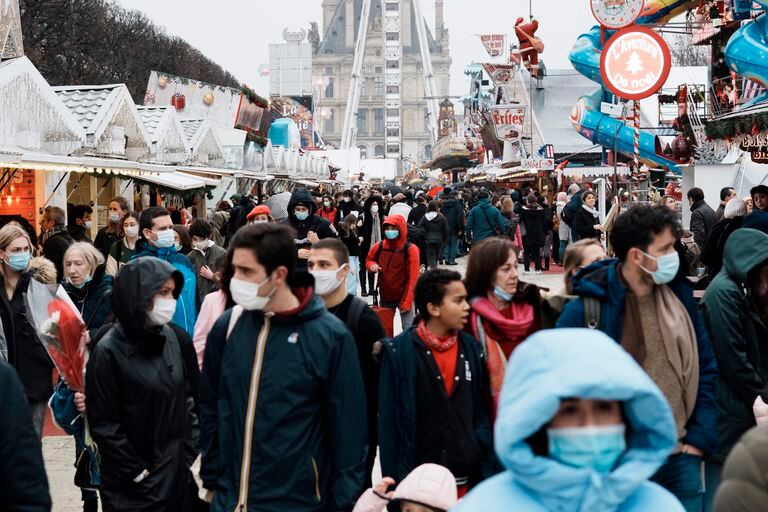 People wearing face masks to slow the spread of Covid-19 while walking in an amusement park in Paris, France