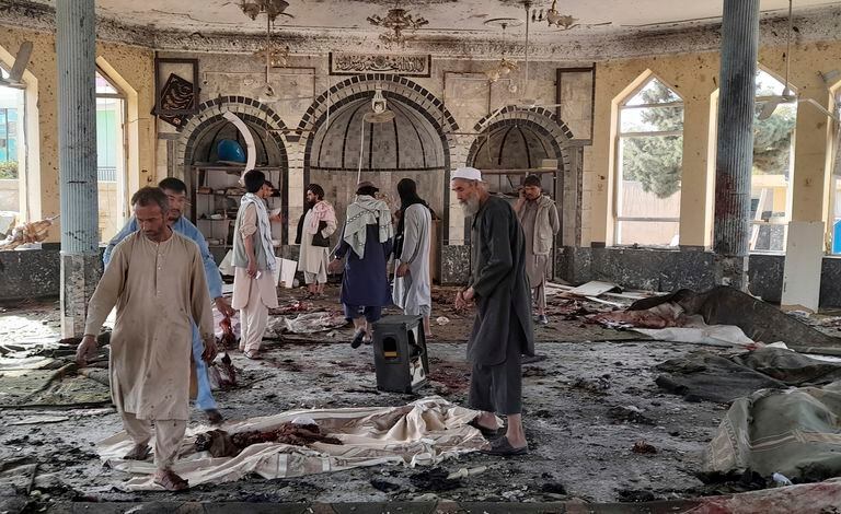 Varias personas inspeccionan los daños en el interior de una mezquita tras una explosión en Kunduz, Afganistán