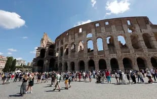 Turistas caminan cerca del Coliseo en Roma, Italia, el 6 de agosto de 2021. (AP Foto/Riccardo De Luca)