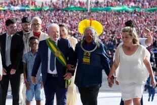 Luiz Inacio Lula da Silva arrives to the Planalto Palace with a group representing diverse segments of society after he was sworn in as new president in Brasilia, Brazil, Sunday, Jan. 1, 2023. (AP Photo/Eraldo Peres)